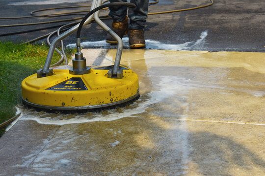 Rotary surface cleaner restoring a concrete driveway