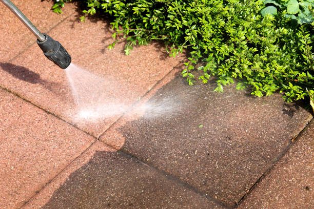 High pressure cleaning lifting years of grime from outdoor pavers
