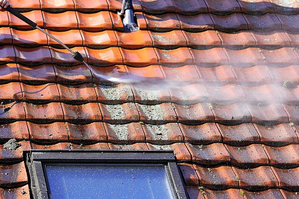 Roof cleaning in progress — moss and grime removed from terracotta tiles