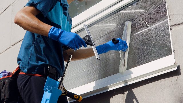 Professional window cleaning with squeegee for a streak-free finish